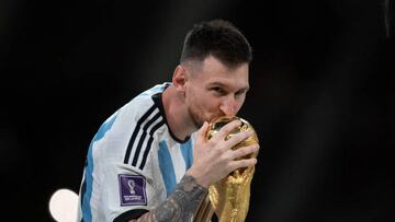 LUSAIL CITY, QATAR - DECEMBER 18: Lionel Messi of Argentina kisses the FIFA World Cup Winners' trophy following the FIFA World Cup Qatar 2022 Final match between Argentina and France at Lusail Stadium on December 18, 2022 in Lusail City, Qatar. (Photo by Visionhaus/Getty Images)