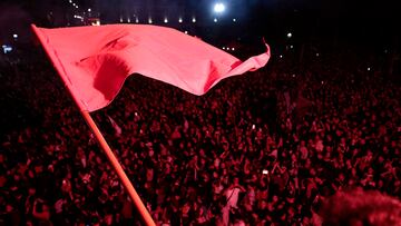A protester holds a flag during a rally organised by members of the alliance of left-wing parties called the "Nouveau Front Populaire" (New Popular Front - NFP), at the Place de la Republique after partial results in the first round of the early French parliamentary elections in Paris, France, June 30, 2024. REUTERS/Abdul Saboor