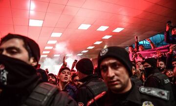 Basaksehir's supporters cheer and light flares as Barcelona's Turkish midfielder Arda Turan (unseen) arrives at Ataturk International Airport in Istanbul on January 13, 2018.