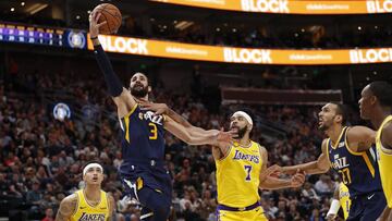 Mar 27, 2019; Salt Lake City, UT, USA; Utah Jazz guard Ricky Rubio (3) drives to the hoop against Los Angeles Lakers forward Kyle Kuzma (0) and Los Angeles Lakers center JaVale McGee (7) in the third quarter at Vivint Smart Home Arena. Mandatory Credit: Jeff Swinger-USA TODAY Sports