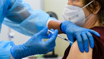 ERFURT, GERMANY - SEPTEMBER 15: Medical staff member inoculates an elderly patient with a booster inoculation of the Pfizer/BioNTech vaccine against Covid-19 on September 15, 2021 in Erfurt, Germany. Booster vaccinations, which are an additional vaccination shot given to strengthen an existing full vaccination, are underway across Germany for elderly patients who were among the first to receive shots in the initial vaccine rollout. (Photo by Jens Schlueter/Getty Images)