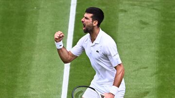 Serbia's Novak Djokovic celebrates winning the third set against Russia's Andrey Rublev during their men's singles quarter-finals tennis match on the ninth day of the 2023 Wimbledon Championships at The All England Tennis Club in Wimbledon, southwest London, on July 11, 2023. (Photo by SEBASTIEN BOZON / AFP) / RESTRICTED TO EDITORIAL USE