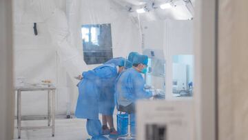 HAIKOU, CHINA - AUGUST 09: Medical workers work on the swab samples in an inflatable laboratory, which is set up to serve the COVID-19 nucleic acid tests, at Hainan International Convention And Exhibition Center on August 9, 2022 in Haikou, Hainan Province of China. The laboratory can cope with 50,000 tubes everyday. (Photo by Li Hao/VCG via Getty Images)