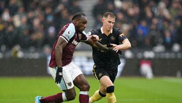 19 February 2022, United Kingdom, London: West Ham United's Michail Antonio (L) and Newcastle United's Emil Krafth battle for the ball during the English Premier League soccer match between West Ham United and Newcastle United at London Stadium.