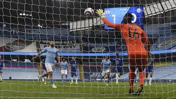 Chelsea's goalkeeper Edouard Mendy saves a penalty shot by Manchester City's Sergio Aguero, left, during the English Premier League soccer match between Manchester City and Chelsea at the Etihad Stadium in Manchester, Saturday, May 8, 2021.(Shau
