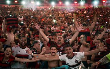 Fans of Brazil's Flamengo react after their team defeated Argentina's River Plate in the Copa Libertadores football final, during the match broadcasting at a Fan Fest event in Maracana stadium, Rio de Janeiro on November 23, 2019.