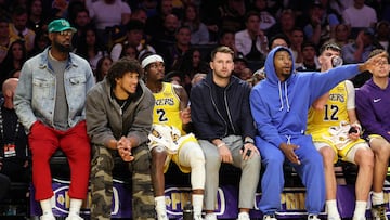 LeBron, vestido de calle, junto al banquillo de los Lakers en el partido contra los Blazers.