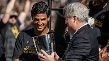 LOS ANGELES, CA - OCTOBER 30: LAFC owner Larry Berg hands the Western Conference Final trophy to Carlos Vela #10 of Los Angeles FC following the the MLS Cup Western Conference Final match against Austin FC at Banc of California Stadium in Los Angeles, California on October 30, 2022.  Los Angeles FC won the match 3-0 (Photo by Shaun Clark/Getty Images)