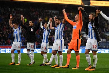 Huddersfield Town players celebrate after beating Manchester United.