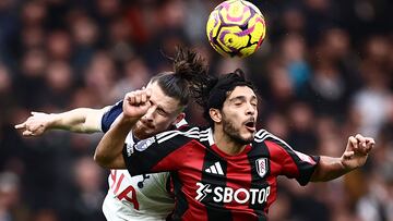 Tottenham Hotspur's Romanian defender #06 Radu Dragusin (L) vies with Fulham's Mexican striker #07 Raul Jimenez (R) during the English Premier League football match between Tottenham Hotspur and Fulham at the Tottenham Hotspur Stadium in London, on December 1, 2024. (Photo by HENRY NICHOLLS / AFP) / RESTRICTED TO EDITORIAL USE. No use with unauthorized audio, video, data, fixture lists, club/league logos or 'live' services. Online in-match use limited to 120 images. An additional 40 images may be used in extra time. No video emulation. Social media in-match use limited to 120 images. An additional 40 images may be used in extra time. No use in betting publications, games or single club/league/player publications. /