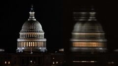 WASHINGTON, DC - DECEMBER 26: The US Capitol Building is seen from the base of the Washington Monument as night falls on December 26, 2020 in Washington, DC. Lawmakers in Congress are continuing to work on the coronavirus relief package following Presiden