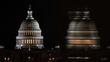 WASHINGTON, DC - DECEMBER 26: The US Capitol Building is seen from the base of the Washington Monument as night falls on December 26, 2020 in Washington, DC. Lawmakers in Congress are continuing to work on the coronavirus relief package following Presiden