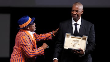 U.S. actor Denzel Washington receives the Honorary Palme d'Or from U.S. director and executive producer Spike Lee ahead of the screening of the film "Highest 2 Lowest" at the 78th edition of the Cannes Film Festival in Cannes, southern France, on May 19, 2025. SAMEER AL-DOUMY/Pool via REUTERS