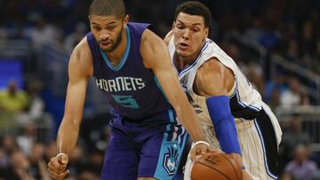 Dec 28, 2016; Orlando, FL, USA; Charlotte Hornets guard Nicolas Batum (5) and Orlando Magic forward Aaron Gordon (00) chase a loose ball during the first quarter of an NBA basketball game at Amway Center. Mandatory Credit: Reinhold Matay-USA TODAY Sports