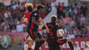 Girona's Spanish defender #03 Miguel Gutierrez and Barcelona's Spanish defender #05 Inigo Martinez Berridi jump for the ball during the Spanish league football match between Girona FC and FC Barcelona at the Montilivi stadium in Girona on September 15, 2024. (Photo by LLUIS GENE / AFP)