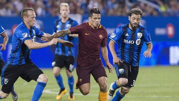 AS Roma's Juan Iturbe, center, holds off a challenge from Montreal Impact's Wandrille Lefevre, left, and Hernan Bernardello during the second half of a friendly soccer match in Montreal, Wednesday, Aug. 3, 2016. (Graham Hughes/The Canadian Press via AP)