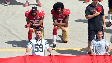 CHARLOTTE, NC - SEPTEMBER 18: Colin Kaepernick #7 and Eric Reid #35 of the San Francisco 49ers kneel during the national anthem before their game against the Carolina Panthers at Bank of America Stadium on September 18, 2016 in Charlotte, North Carolina. Grant Halverson/Getty Images/AFP
== FOR NEWSPAPERS, INTERNET, TELCOS & TELEVISION USE ONLY ==