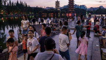 Tourists come to watch the sunset at the four lakes scenic area in Guilin on August 8, 2020. (Photo by NICOLAS ASFOURI / AFP)