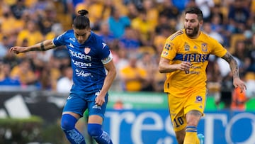 Andre Pierre Gignac (R) of Tigres vies for the ball with Alexis Pena (L) of Necaxa during the  Mexican Apertura 2022 football tournament match at the Universitario stadium in Monterrey, Mexico, on August 27,  2022. (Photo by Julio Cesar AGUILAR / AFP)