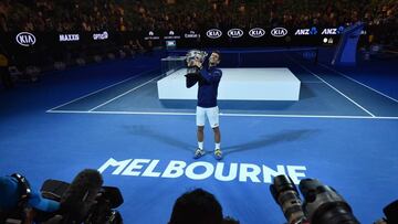 Novak Djokovic poses with the winner's trophy in Melbourne.