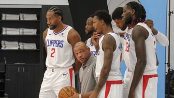 FILE - In this Sept. 29, 2019, file photo, Los Angeles Clippers, including forward Kawhi Leonard (2), Paul George (13) and head coach Doc Rivers, second from front left, join teammates for photos during the NBA basketball team's media day in Los Angeles. The NBA's balance of power has shifted to the Clippers, who have never advanced beyond the second round let alone won a championship. All that is expected to change behind Leonard and George, both regarded as two of the best two-way players in the league. (AP Photo/Ringo H.W. Chiu, File)