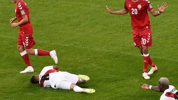 Denmark&#039;s forward Yussuf Poulsen (R) reacts after bringing down  Peru&#039;s midfielder Christian Cueva (C) to concede a penalty awarded after VAR review during the Russia 2018 World Cup Group C football match between Peru and Denmark at the Mordovia