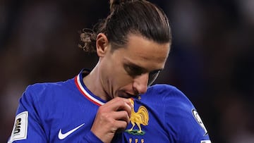 France's forward #20 Florian Thauvin kisses the French badge as he celebrates after scoring France's third goal during the FIFA World Cup 2026 Group D European qualification football match between France and Azerbaidjan at the Parc des Princes Stadium in Paris, on October 10, 2025. (Photo by Anne-Christine POUJOULAT / AFP)