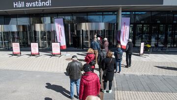 People stand in line to get a vaccine against the coronavirus disease (COVID-19) outside the Stockholmsmassan exhibition center, turned mass vaccination centre, in Stockholm, Sweden, April 8, 2021. Fredrik Sandberg/TT News Agency via REUTERS     ATTENTION