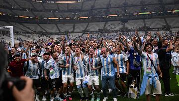 Argentina players celebrate with supporters after they won the Qatar 2022 World Cup final football match between Argentina and France at Lusail Stadium in Lusail, north of Doha on December 18, 2022. (Photo by Kirill KUDRYAVTSEV / AFP)