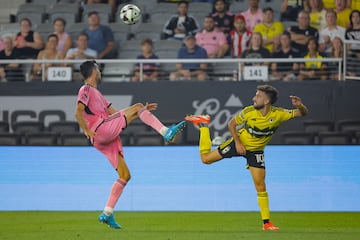 Inter Miami midfielder Sergio Busquets (5) and Columbus Crew forward Diego Rossi (10) go for the ball.