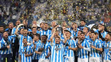 Racing Club's Argentine defender Ivan Pillud (C) carries the trophy after winning the 2022 Supercopa Internacional football match between Boca Juniors and Racing Club, at the Hazza bin Zayed Stadium in Al-Ain on January 20, 2023. (Photo by KARIM SAHIB / AFP) (Photo by KARIM SAHIB/AFP via Getty Images)