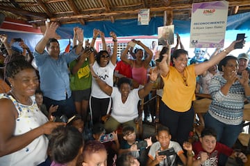 The mother of Cuban wrestler Mijain Lopez, Leonor Nunez (C), celebrates with friends and neighbours the victory of her son after he won the men's greco-roman 130kg wrestling event at the Paris 2024 Olympic Games, at her home in the town of Herradura, Pinar del Rio province, Cuba, on August 6, 2024. (Photo by YAMIL LAGE / AFP)