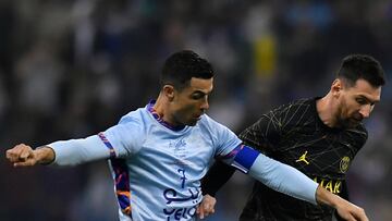 RIYADH, SAUDI ARABIA - JANUARY 19: Leo Messi of Paris Saint-Germain and Cristiano Ronaldo of Ruyadh XI fight for possession during the friendly match between Paris Saint-Germain and Riyadh XI at King Fahd International Stadium on January 19, 2023 in Riyadh, Saudi Arabia. (Photo by Aurelien Meunier - PSG/PSG via Getty Images)