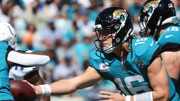 Trevor Lawrence, #16 of the Jacksonville Jaguars, hands off the ball