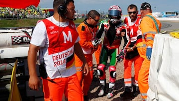 Aprilia Racing Team Gresini MotoGP rider Aleix Espargaro of Spain is held by paramedic after his crash during warm up of the German Grand Prix MotoGP at the Sachsenring circuit in the eastern town of Hohenstein-Ernstthal, Germany, July 15, 2018. REUTERS/Fabrizio Bensch