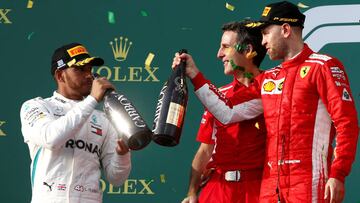 Formula One F1 - Australian Grand Prix - Melbourne Grand Prix Circuit, Melbourne, Australia - March 25, 2018 Ferrari's Sebastian Vettel celebrates his win on the podium with Mercedes' Lewis Hamilton REUTERS/Brandon Malone