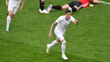 Uruguay's defender Jose Gimenez (R) celebrates scoring the opening goal during the Russia 2018 World Cup Group A football match between Egypt and Uruguay at the Ekaterinburg Arena in Ekaterinburg on June 15, 2018. / AFP PHOTO / HECTOR RETAMAL / RESTR