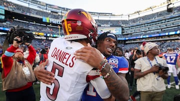 EAST RUTHERFORD, NEW JERSEY - NOVEMBER 03: Jayden Daniels #5 of the Washington Commanders and Malik Nabers #1 of the New York Giants embrace after the game at MetLife Stadium on November 03, 2024 in East Rutherford, New Jersey. Luke Hales/Getty Images/AFP (Photo by Luke Hales / GETTY IMAGES NORTH AMERICA / Getty Images via AFP)