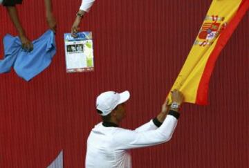 Rafa Nadal firma un autográfo en una bandera de España tras ganar el partido de tercera ronda ante Alexander Zverev.