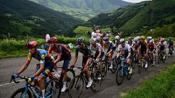 The pack of riders cycles in the ascent of Col de Soudet during the 5th stage of the 110th edition of the Tour de France cycling race, 163 km between Pau and Laruns, in the Pyrenees mountains in southwestern France, on July 5, 2023. (Photo by Marco BERTORELLO / AFP)