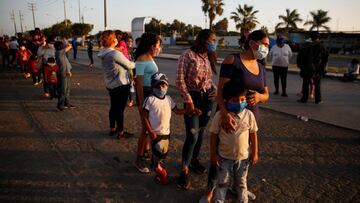 People are seen outside of a Peruvian Air Force base while waiting for flights home to the Peruvian Amazon amid the spread of the coronavirus disease (COVID-19), in Lima, Peru April 24, 2020. REUTERS/Sebastian Castaneda NO RESALES. NO ARCHIVES