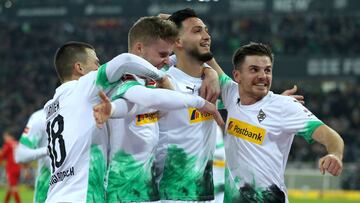 MOENCHENGLADBACH, GERMANY - DECEMBER 07: Ramy Bensebaini of Borussia Monchengladbach celebrates with his team mates after scoring his team's first goal during the Bundesliga match between Borussia Moenchengladbach and FC Bayern Muenchen at Borussia-P
