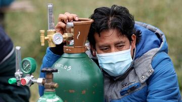 LIMA, PERU - JUNE 08: A buyer wearing a protective mask waits in a long queue to refill medical oxygen tanks at Criogas company on June 8, 2020 in Lima, Peru. Due to increase of the demand, oxygen is in short supply and Peruvians struggle to buy it, at higher prices. (Photo by Raul Sifuentes/Getty Images)