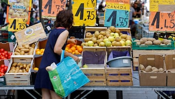 Price tags are seen as a woman shops at a local market in Nice, France.