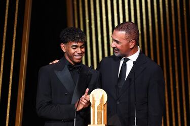 El exfutbolista holandés Ruud Gullit entrega el Trofeo Kopa al mejor jugador sub-21 al delantero español del Barcelona Lamine Yamal durante la ceremonia del Balón de Oro 2024.