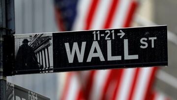 FILE PHOTO: Raindrops hang on a sign for Wall Street outside the New York Stock Exchange in Manhattan in New York City, New York, U.S., October 26, 2020. REUTERS/Mike Segar/File Photo