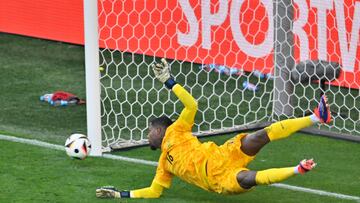 France's goalkeeper #16 Mike Maignan concedes the equalising goal 1:1 shot from the penalty spot by Poland's forward #09 Robert Lewandowski (Not in picture) during the UEFA Euro 2024 Group D football match between France and Poland at the BVB Stadion in Dortmund on June 25, 2024. (Photo by INA FASSBENDER / AFP)