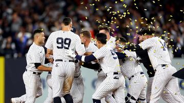 NEW YORK, NEW YORK - SEPTEMBER 22: Josh Donaldson #28 of the New York Yankees is swarmed by his teammates after he drove in the game winning run in the 10th inning against the Boston Red Sox at Yankee Stadium on September 22, 2022 in the Bronx borough of New York City. The New York Yankees defeated the Boston Red Sox 5-4 in 10 innings.   Elsa/Getty Images/AFP