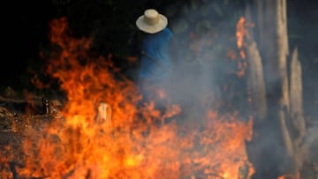 FILE PHOTO: A man works in a burning tract of Amazon jungle as it is being cleared by loggers and farmers in Iranduba, Amazonas state, Brazil August 20, 2019. REUTERS/Bruno Kelly/File Photo