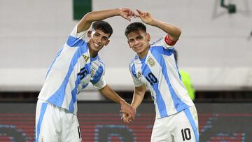 Argentina's midfielder #10 Claudio Echeverri (R) celebrates with teammate defender #16 Lucas Obregon after scoring his team's first goal during the 2025 South American U-20 football championship final round match between Uruguay and Argentina at the Br�gido Iriarte stadium in Caracas on February 7, 2025. (Photo by Edison GAMEZ / AFP)